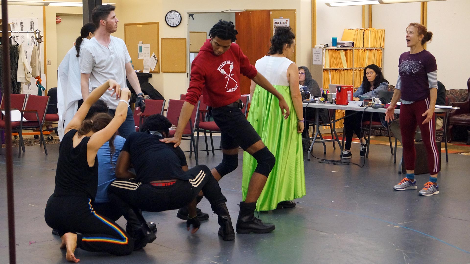 Choreographer Christina McCarthy instructs a group of actors in rehearsal.