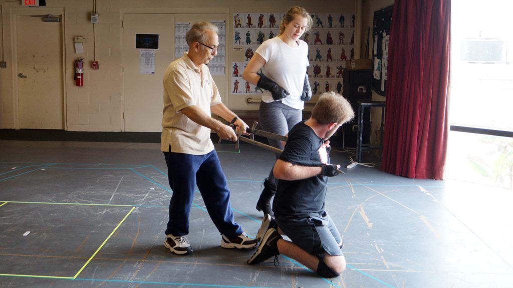 Tony Simotes demonstrates fight choreography to cast members.