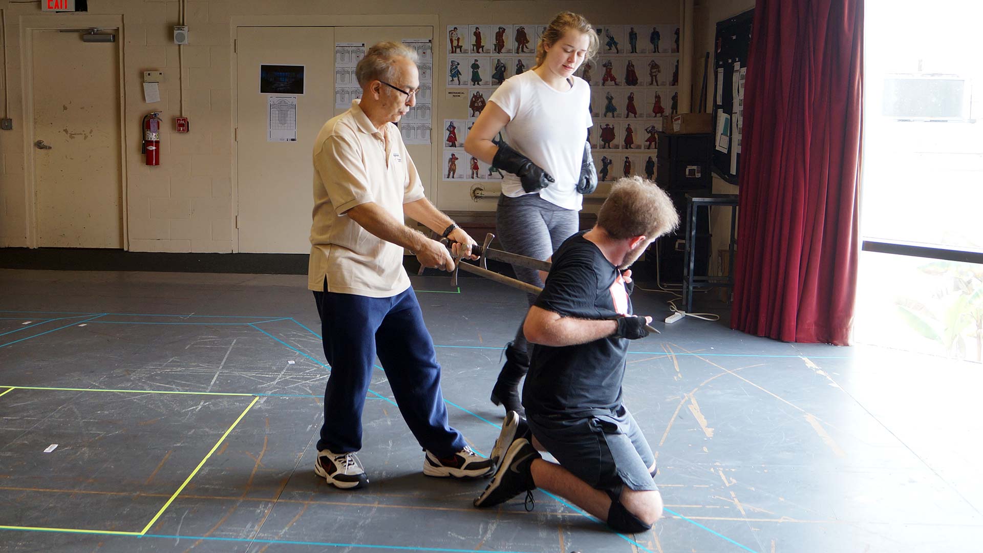 Tony Simotes demonstrates fight choreography to cast members.
